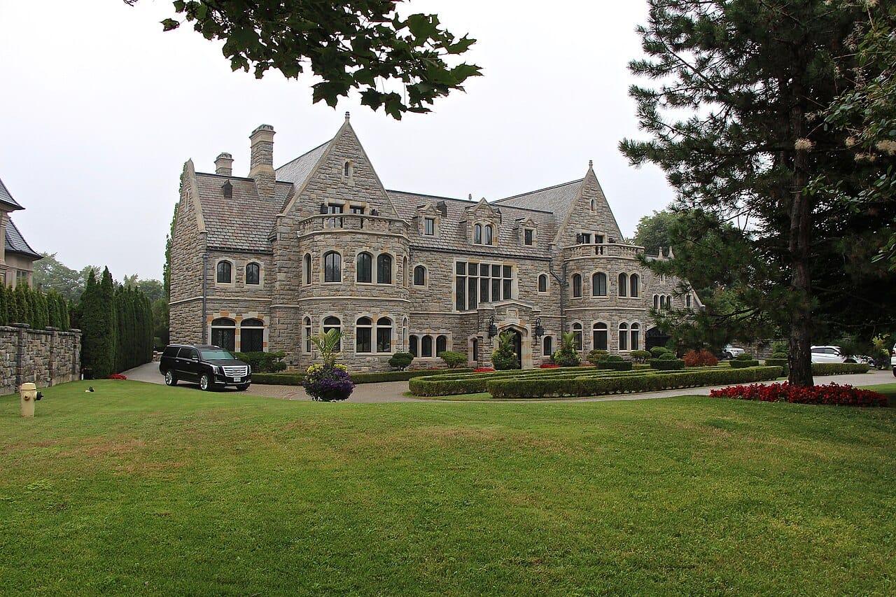 A stone manor house and formal gardens on Park Lane Circle, the Bridle Path.